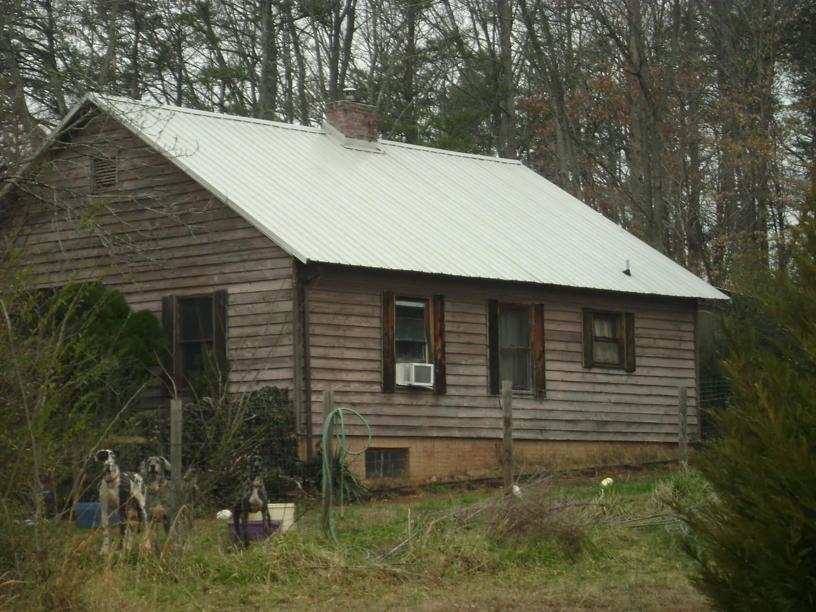 White metal roof on an old wood sided farmhouse, from a Metal Roof Installation job in Morris